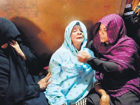 Rukiya, who lost 11 family members in the boat accident, being comforted by relatives