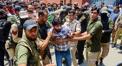 Police detain job aspirants, who had applied for various posts in the Fire and Emergency Services, during their protest march towards Raj Bhawan on Saturday. (Photo | PTI)