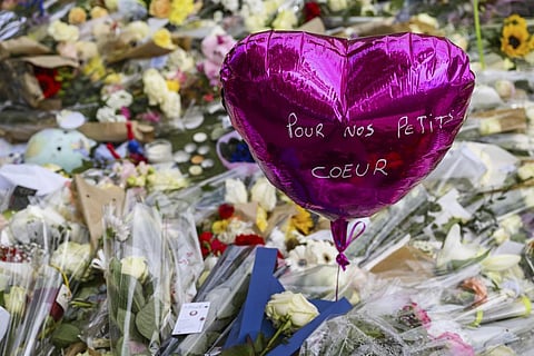Flowers are laid down at a children's playground in Annecy, France, Saturday, June 10, 2023 following a knife attack on Thursday, June 8, 2023. (AP)