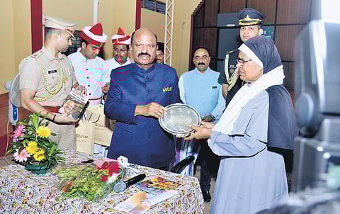 Sr Elise Mary, head of Central Institute of Mental Retardation, giving a memento to West Bengal Governor C V Ananda Bose at the special school at Murinjapalam on Sunday