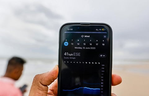 A man checks the wind speed ahead of the landfall of Biparjoy cyclone, in Mandvi of Kutch district, Monday, June 12, 2023. (Photo | PTI)