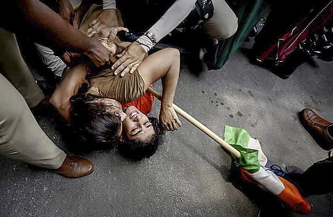 Representational Image: Security personnel detain wrestlers Vinesh Phogat and Sangeeta Phogat during wrestlers protest march towards the new Parliament building, in New Delhi. (Photo | PTI)