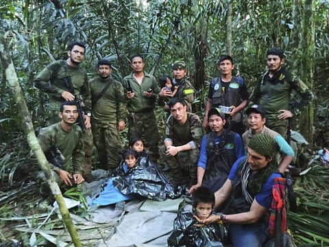 Soldiers and Indigenous men pose with the four Indigenous children who were missing after a deadly plane crash, in the Solano jungle, Colombia, June 9, 2023. (Photo | AP)