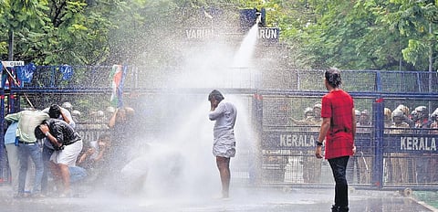 Police using water cannon to disperse KSU and Youth Congress workers who took out a protest march to the office of City Police Commissioner | A Sanesh