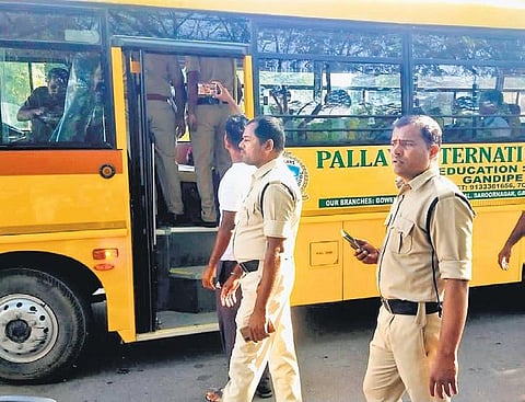 Police check a school bus in Hyderabad on Tuesday