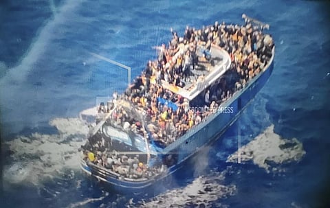 scores of people covering practically every free stretch of deck on a battered fishing boat that later capsized and sank off southern Greece. (Photo | AP)