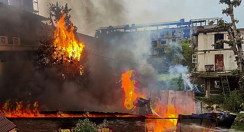 Flames and smoke billows out after an old warehouse owned by a retired bureaucrat set ablaze amid violence in Manipur. (Photo |PTI)