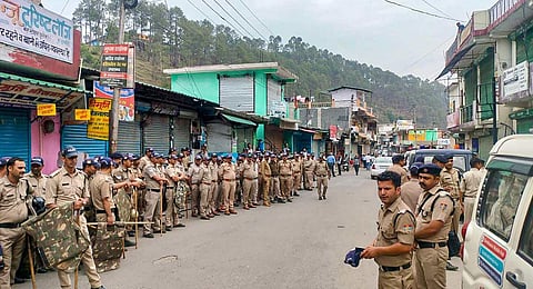 Security personnel deployed in Purola after the imposition of section 144 of the CrPC by district administration, in Uttarkashi district. (Photo | PTI)
