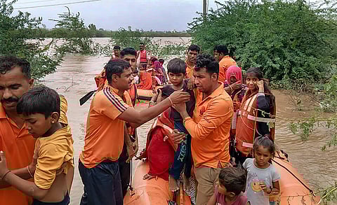SDRF personnel rescue people living in low-lying areas of Bhinmal village in Jalore district, Sunday, June 18, 2023. ( PTI Photo)