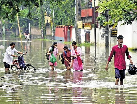 People wade through a waterlogged road in Guwahati on Saturday | pti