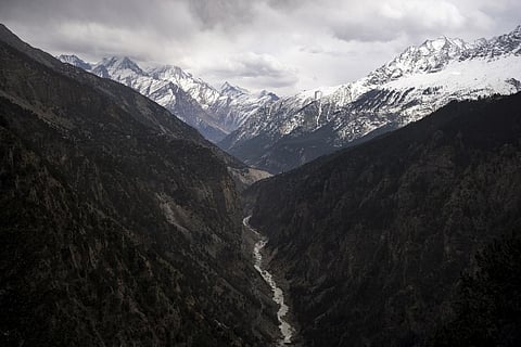 The Sutlej River flows in the valley below the tall snowy peaks in the Kinnaur district of the Himalayan state of Himachal Pradesh. (Photo | AP)