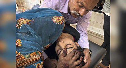 A couple try to pacify their daughter suffering from heat related ailment as she is brought to the government district hospital in Ballia, Uttar Pradesh. (Photo | AP)