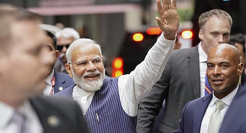 Indian Prime Minister Narendra Modi, center, greets supporters as he arrives in New York on Tuesday, June 20, 2023. (AP Photo)