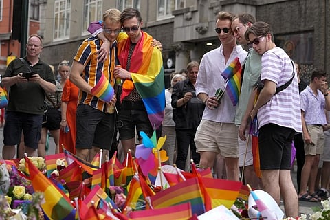 People react as they lay flowers at the scene of a shooting in central Oslo, Norway, Saturday, June 25, 2022. (Photo | AP)