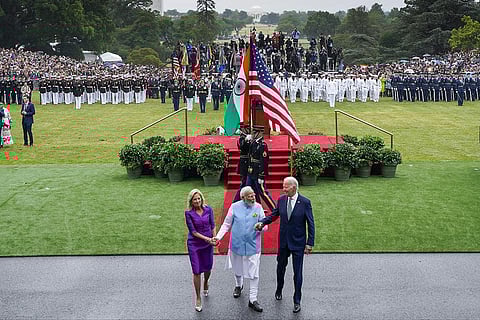 US President Joe Biden and first lady Jill Biden hold Prime Minister Narendra Modi’s hands as they walk into the White House. (Photo | AP)