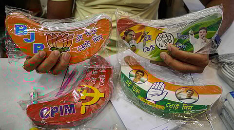 FILE: A shopkeeper displays merchandise related to different political parties for sale ahead of the West Bengal Panchayat elections. (Photo|PTI)