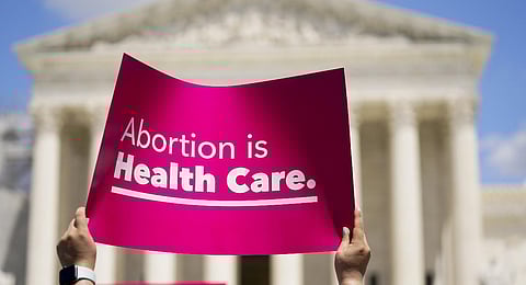 Demonstrators hold signs as they rally outside the Supreme Court building during the Women's March in Washington. (Photo | PTI)