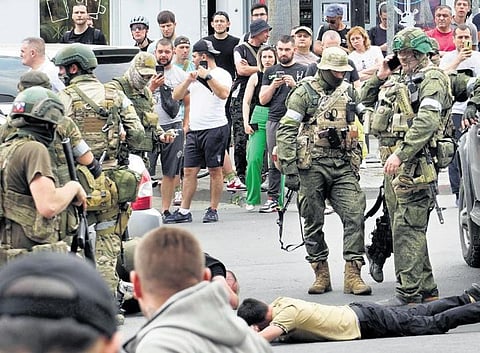 Members of mercenary Wagner group detain a man in the city of Rostov-on-Don. (Photo | AFP)