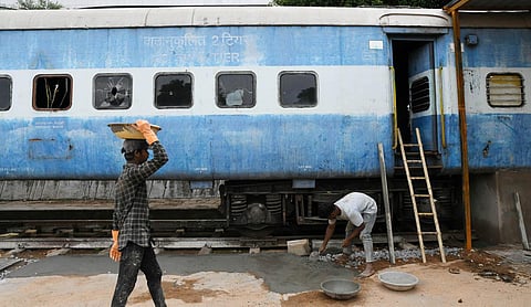 Workers getting the first-of-its-kind ‘restaurant on wheels’ ready to host guests near the Necklace Road Railway Station. (Photo | Vinay Madapu, EPS)