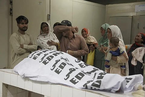 Representational Image: A family mourns next to the body of their family member, who died in the stampede, at a morgue, in Karachi, Pakistan, Friday, March 31, 2023. (Photo | AP)