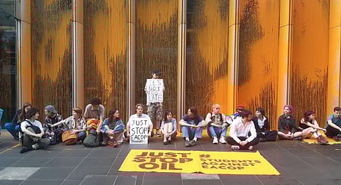 Just Stop Oil climate activists stage a sit-in after throwing orange paint at the UK headquarters of TotalEnergies in the UK. (Photo | Just Stop Oil Twitter)