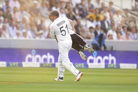 England's Johnny Bairstow carries a Just Stop Oil protestor off the pitch, during day one of the second Ashes Test cricket match at Lord's Cricket Ground in London, June 28, 2023. (Photo | AP)