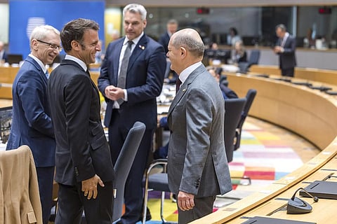 France's President Emmanuel Macron, second left, speaks with Germany's Chancellor Olaf Scholz, right, during a round table meeting at an EU summit. (Photo | AP)