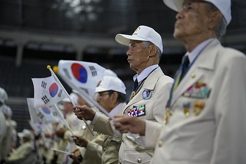 People holding South Korean flag. (Photo | AP)