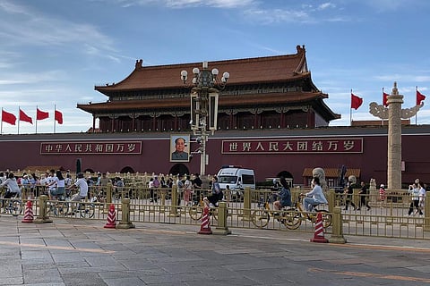 Residents past by a a police van parked in front of Tiananmen Gate in Beijing, Sunday, June 4, 2023. (Photo | AP)
