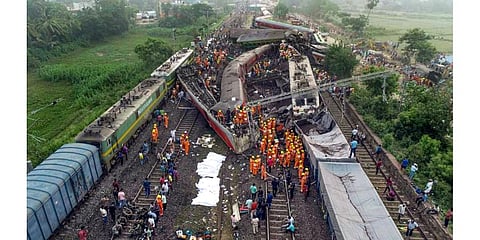 Locals, security personnel and NDRF during the search and rescue operation at the site where Coromandel, Bengaluru-Howrah Express trains derailed last night in Balasore district. (Photo | PTI)