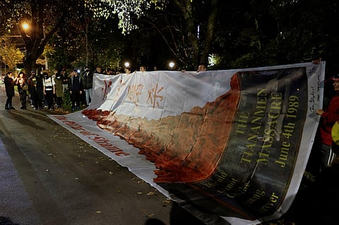 Pro-Democracy supporters attend a candlelight vigil on the 34th anniversary of the 1989 Tiananmen Square crackdown, outside the Chinese Consulate-General in Melbourne. (AFP)