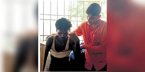 A local attending to a victim of train accident on Saturday | Express