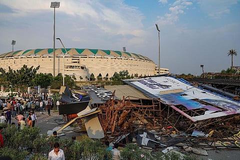 Police personnel carry out a rescue operation after a roadside hoarding structure fell on a Scorpio vehicle near Ekana stadium in Lucknow, Monday, June 5, 2023. (Photo | PTI)