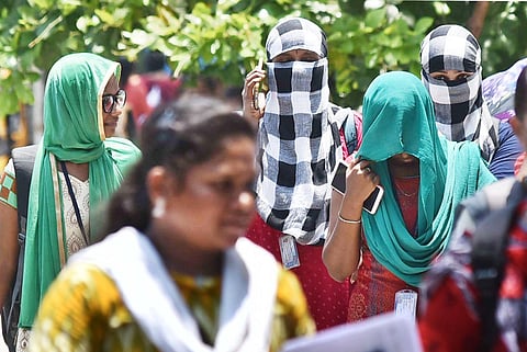 Students cover their faces to beat the heat, in chennai on Friday (Photo | EPS/ P Jawahar)
