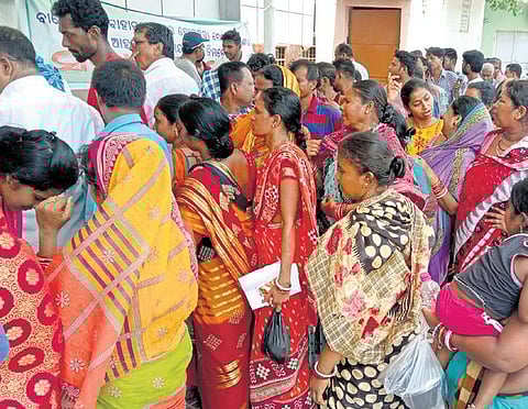 Relatives of people injured in the Bahanaga train accident wait in queue for food at the SCB Medical College and Hospital at Cuttack on Sunday I Express
