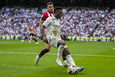 Real Madrid's Vinicius Junior, foreground, duels for the ball with Athletic Bilbao's Aitor Paredes during the Spanish La Liga soccer match at the Santiago Bernabeu stadium in Madrid. (Photo | AP)
