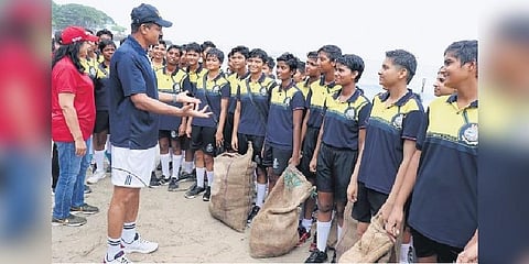 Southern Naval Command Chief Vice Admiral M A Hampiholi interacting with students during the coastal clean-up drive on Monday