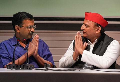 Samajwadi Party President Akhilesh Yadav and Delhi Chief Minister Arvind Kejriwal exchange greetings during a joint press conference, at SP office in Lucknow, June 7, 2023. (PTI)