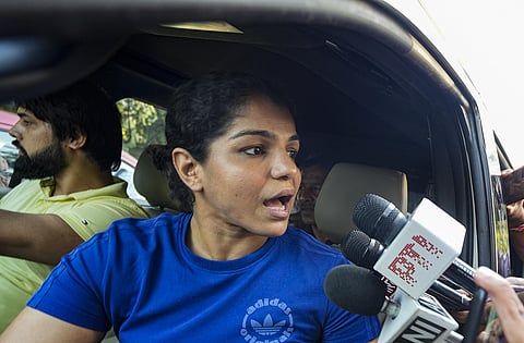 Wrestler Sakshi Malik speaks with the media as she leaves from the residence of Union Minister for Youth Affairs & Sports Anurag Thakur after a meeting. (Photo | PTI)