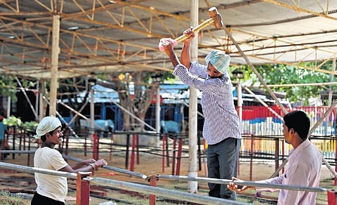 Workers make arrangements for the distribution of fish prasadam at the Exhibition Grounds in Nampally on Tuesday | Sri Loganathan Velmurugan
