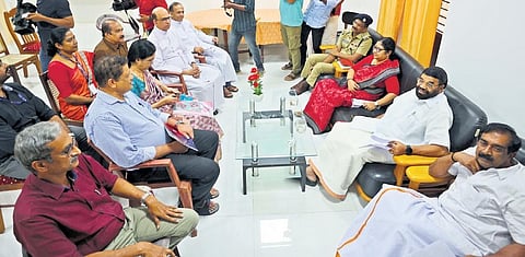 Ministers R Bindu and V N Vasavan and Chief Whip N Jayaraj holding talks with management of the college in Kanjirappally on Wednesday