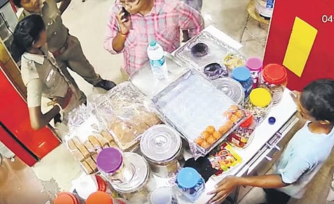 A screengrab from the viral video of Guduvanchery policewomen at the cash counter of an eatery in Padappai on Sunday | Express