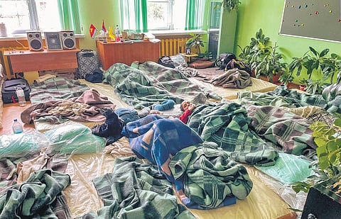 Air India flight passengers stay at makeshift accommodation in a nearby school after it had to land at the Sokol Airport in Magadan, Russia. (Photo | PTI)