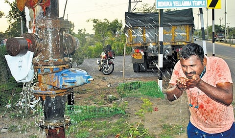 A lorry driver stops by to quench his thirst from a leaking pipe of Mission Bagiratha in Karimnagar district on Wednesday as temperature continues to stay high