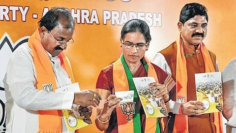  Union Minister Bharati Pravin Pawar releases a booklet on the nine-year rule of Prime Minister Narendra Modi in Vijayawada on Wednesday I Prasant Madugula 
