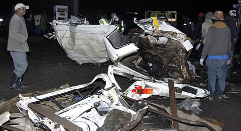 People stand near the wreckage of vehicles after a fatal accident in Londiani, Kenya. (Photo | AP)