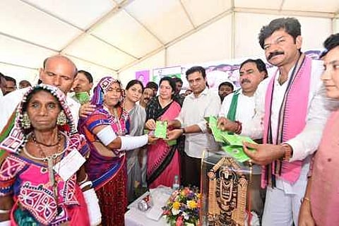 MAUD Minister KT Rama Rao distributes pattas to podu farmers on Friday