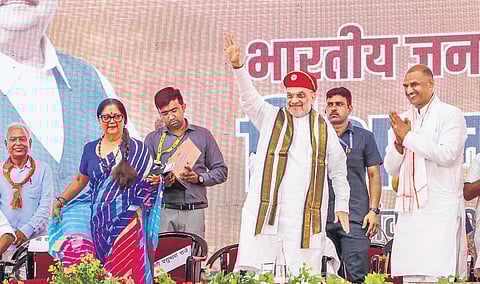 Amit Shah with Rajasthan BJP president CP Joshi and former Rajasthan chief minister Vasundhara Raje at a rally in Udaipur on Friday | pti