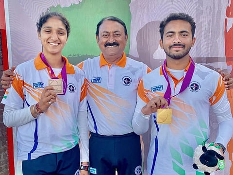 Under-21 bronze medal winner Bhajan Kaur (left) and Under-21 world champion Parth Salunkhe with Indian high-performance director Sanjeeva Singh (middle) on July 10, 2023. (PTI)