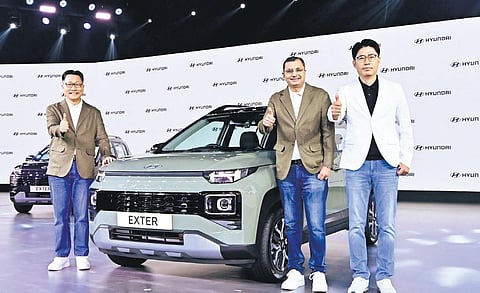 (L-R) Unsoo Kim, MD & CEO, Hyundai Motor India; Tarun Garg, COO; J T Park, executive director (sales, marketing & service), at the launch of Hyundai Exter in New Delhi.